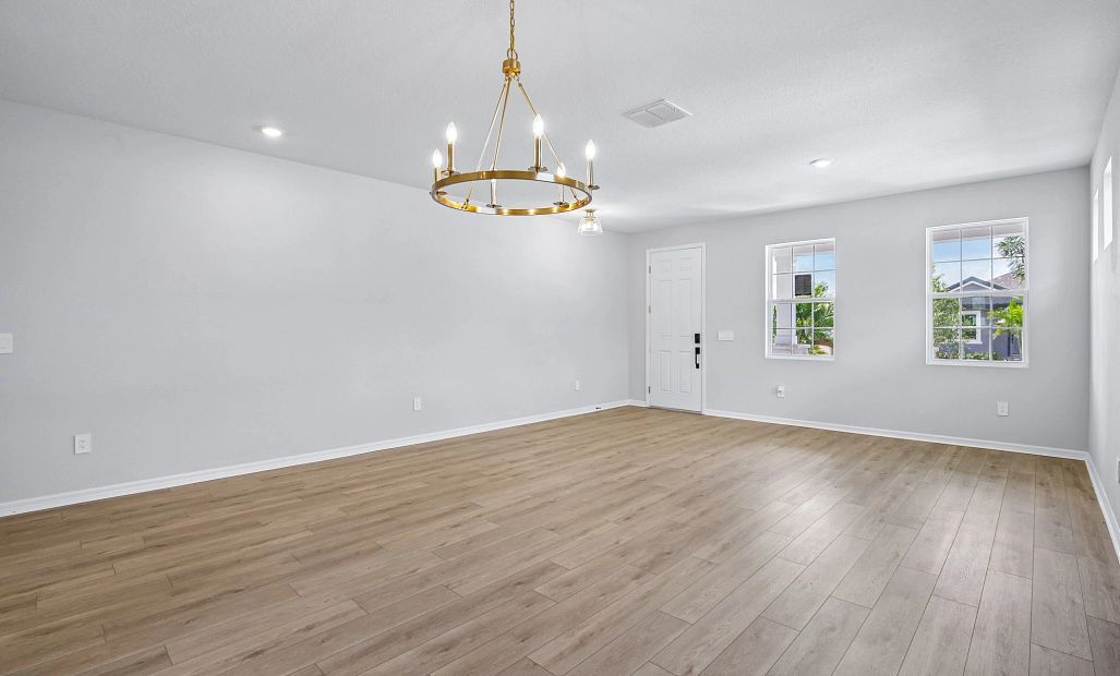 The dining room space is centered with a beautiful light fixture that is part of the AW Collection®