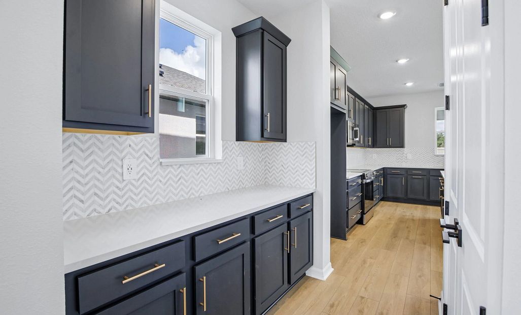 The dining room leads you into the butler's pantry that it outfitted with the AW Collection®