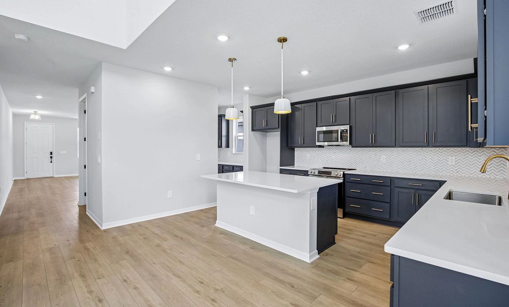 The spacious kitchen features a large island perfect for entertaining