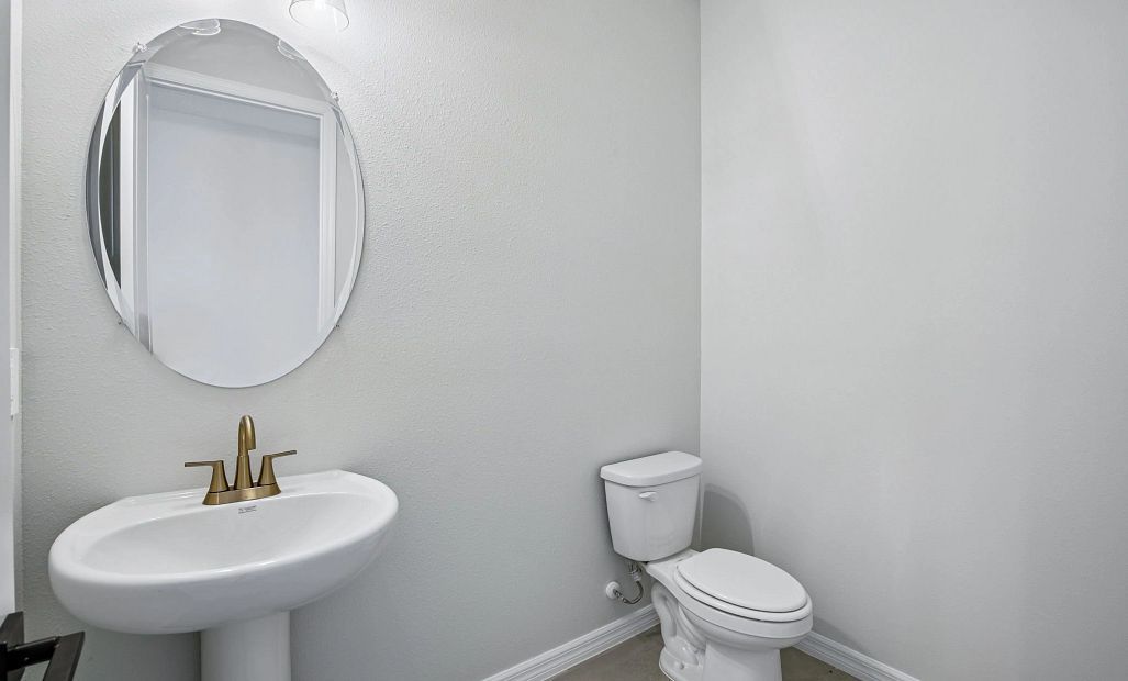 Half bathroom located just off the kitchen