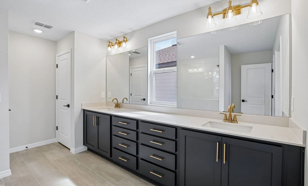 The primary bathroom features double sinks, plenty of cabinet space and aspects of AW Collection®