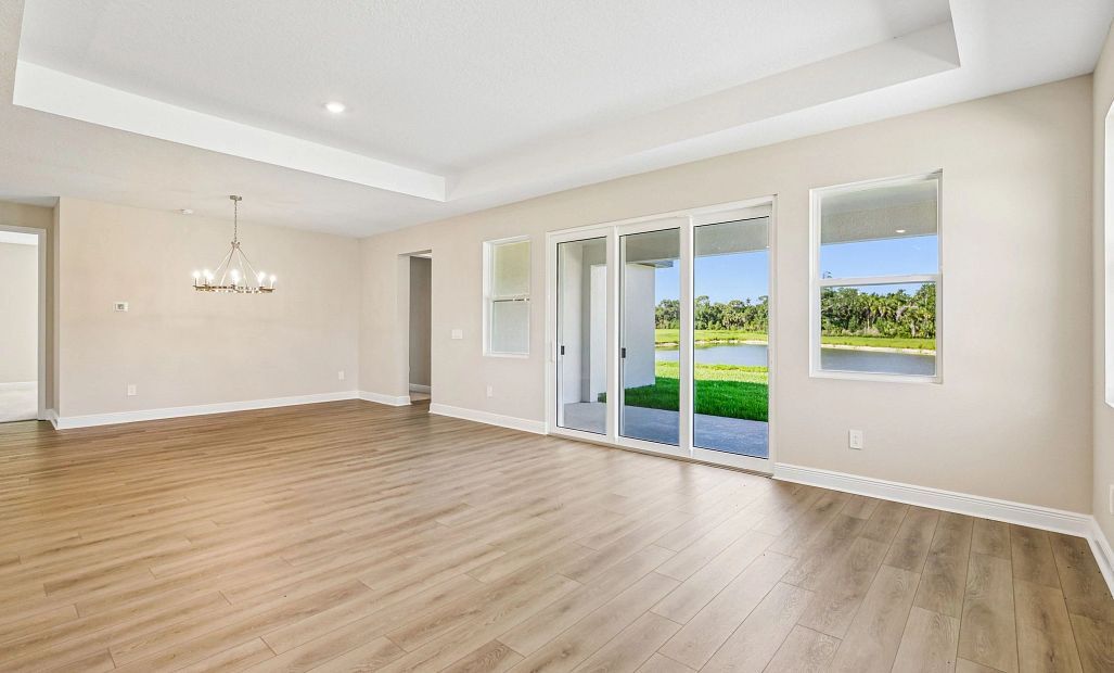 The dining space opens up into the family room space which features a tray ceiling