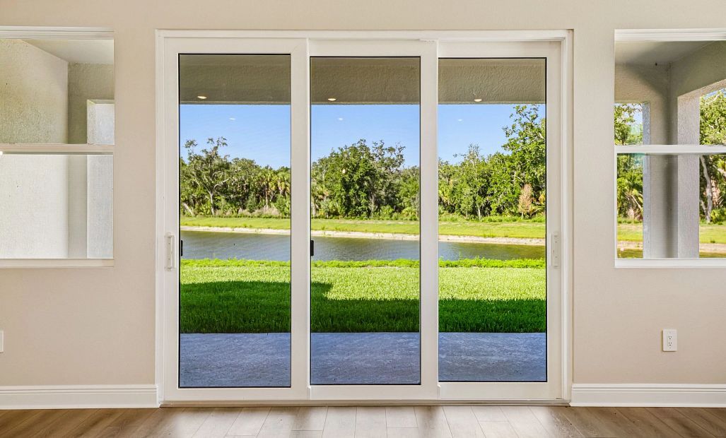 The family room looks out through the large sliding glass doors on to the pond view