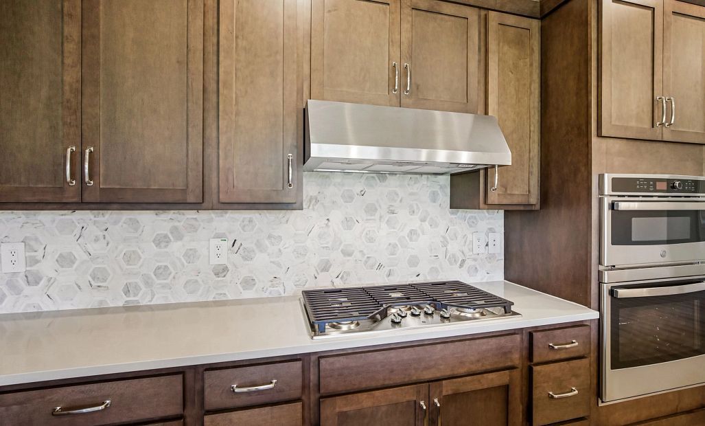 This kitchen features our gourmet kitchen layout which includes a gas range with vent hood and a