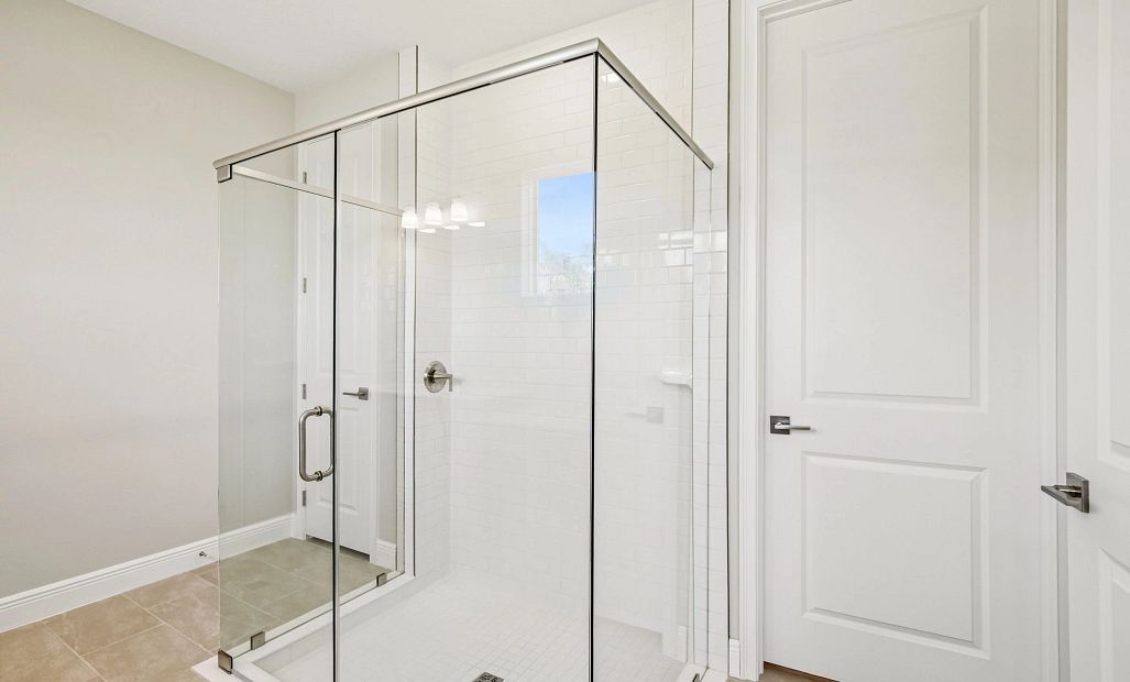 The primary bathroom has a large walk-in shower