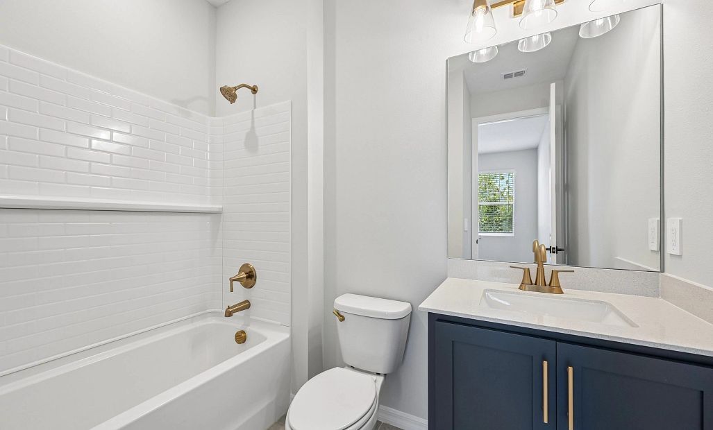 Guest suite with an attached bathroom featuring aspects of AW Collection® Sapphire