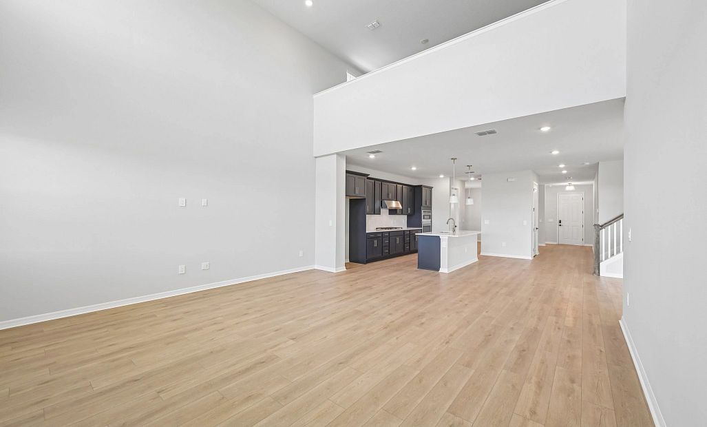 Off the kitchen is the spacious two-story great room which opens up to the upstairs loft space