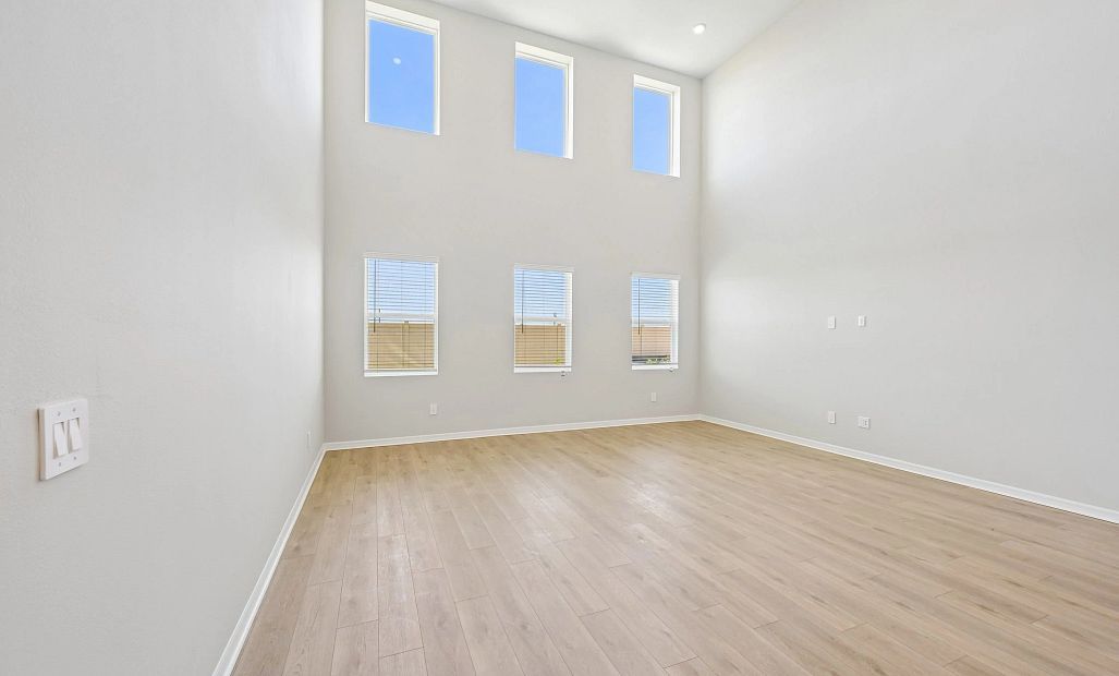 The two-story great room features six large windows creating so much natural light
