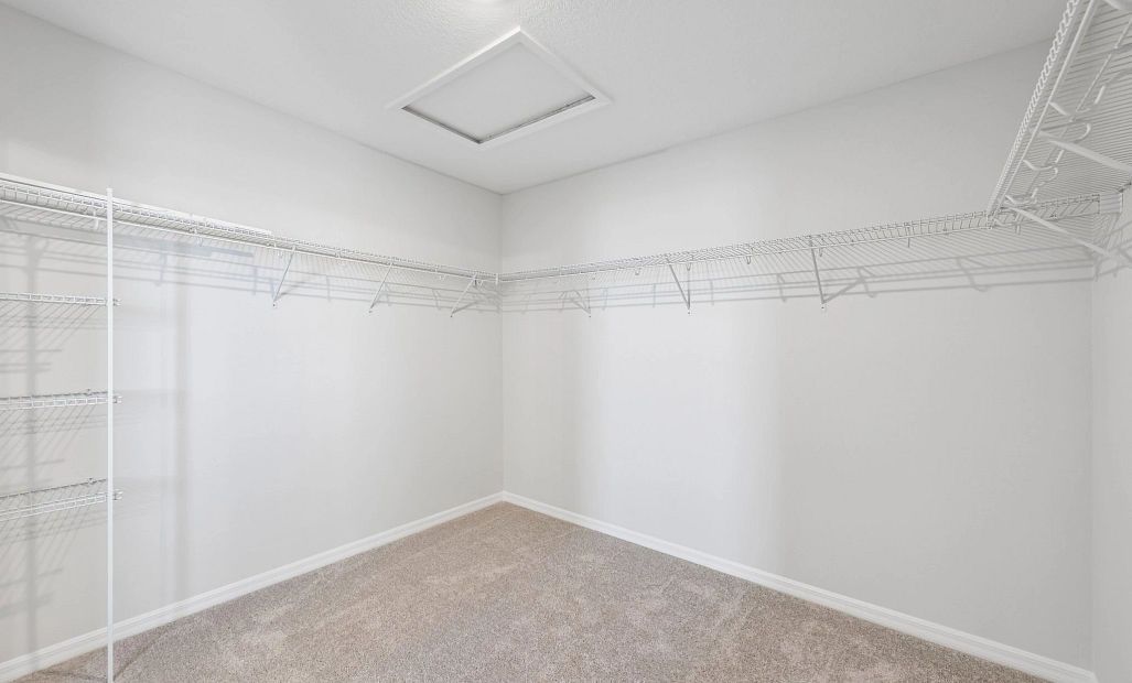 A very large walk-in closet is located off the primary bathroom