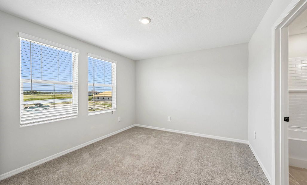 Bedroom 4 is located off the front of the home and features two large windows