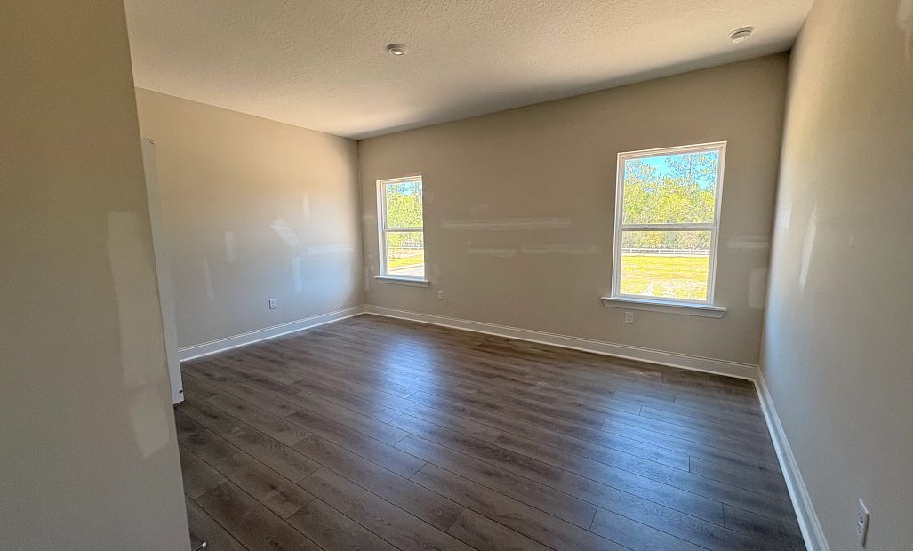 Bedroom 3 located off the side of the home featuring two large windows - under construction