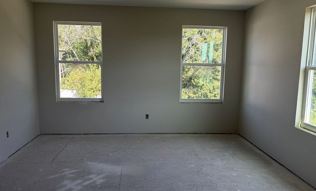 Spacious Primary Bedroom featuring a tray ceiling - under construction