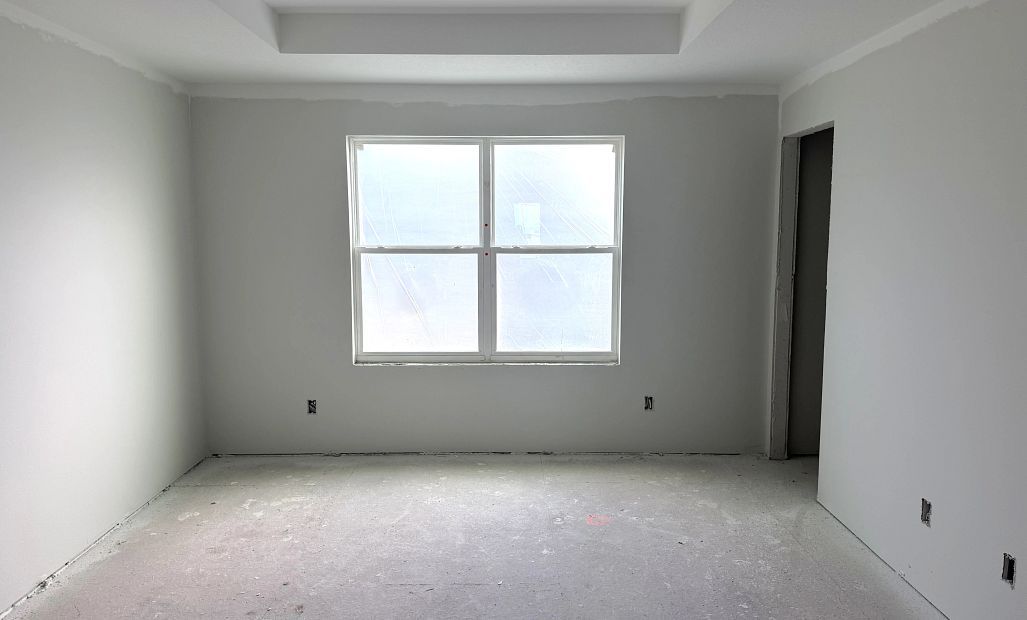 Primary bedroom featuring a tray ceiling - under construction