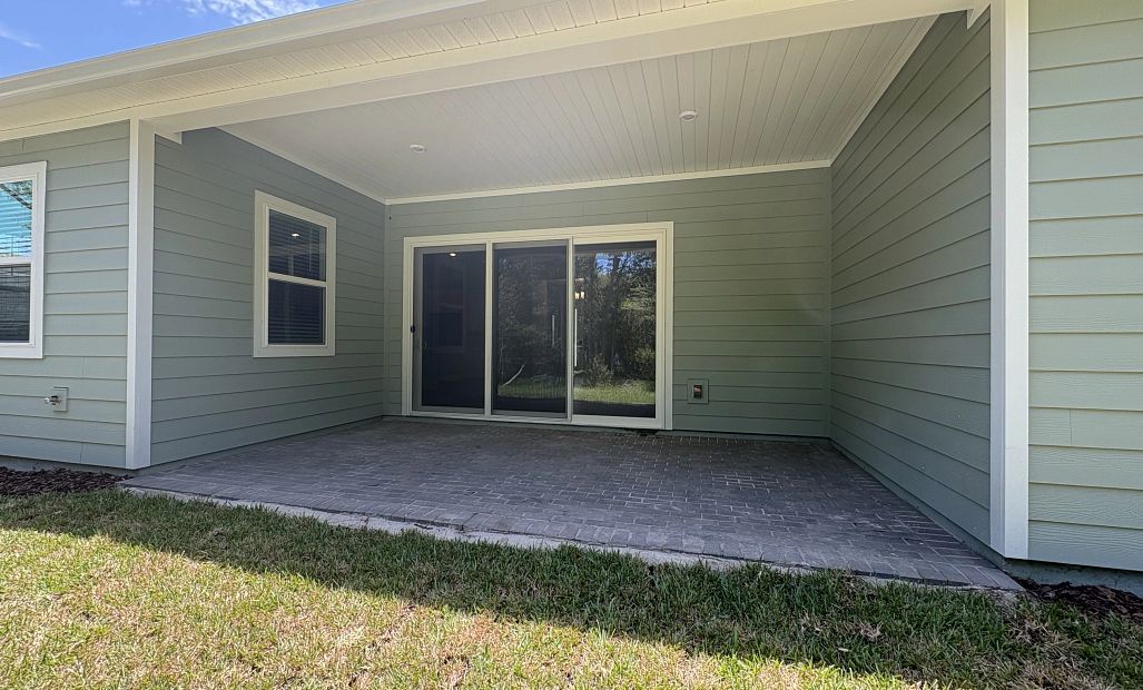 Large sliding glass door welcomes you out onto the covered back lanai