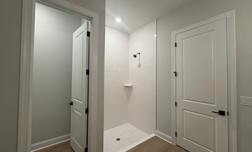 Primary bathroom features a separate toilet room and a walk-in shower