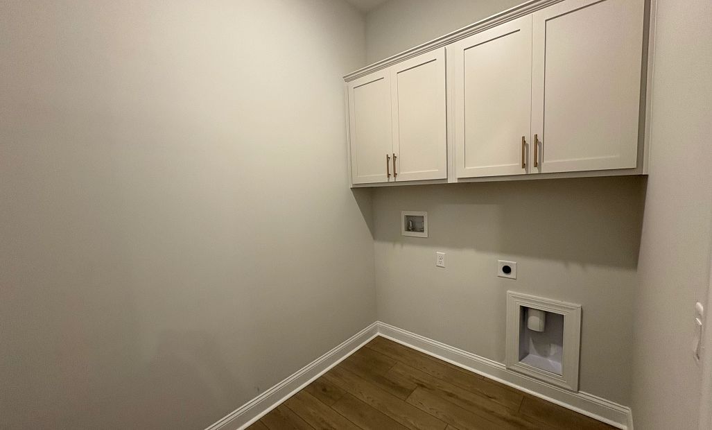 Laundry room features upper cabinets