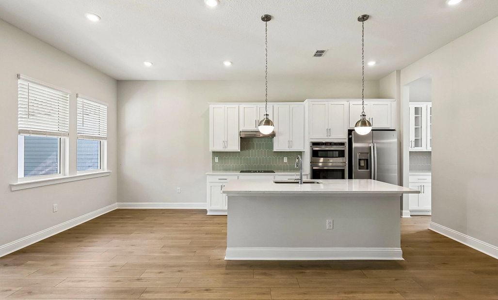 The kitchen has a dining nook connected to it