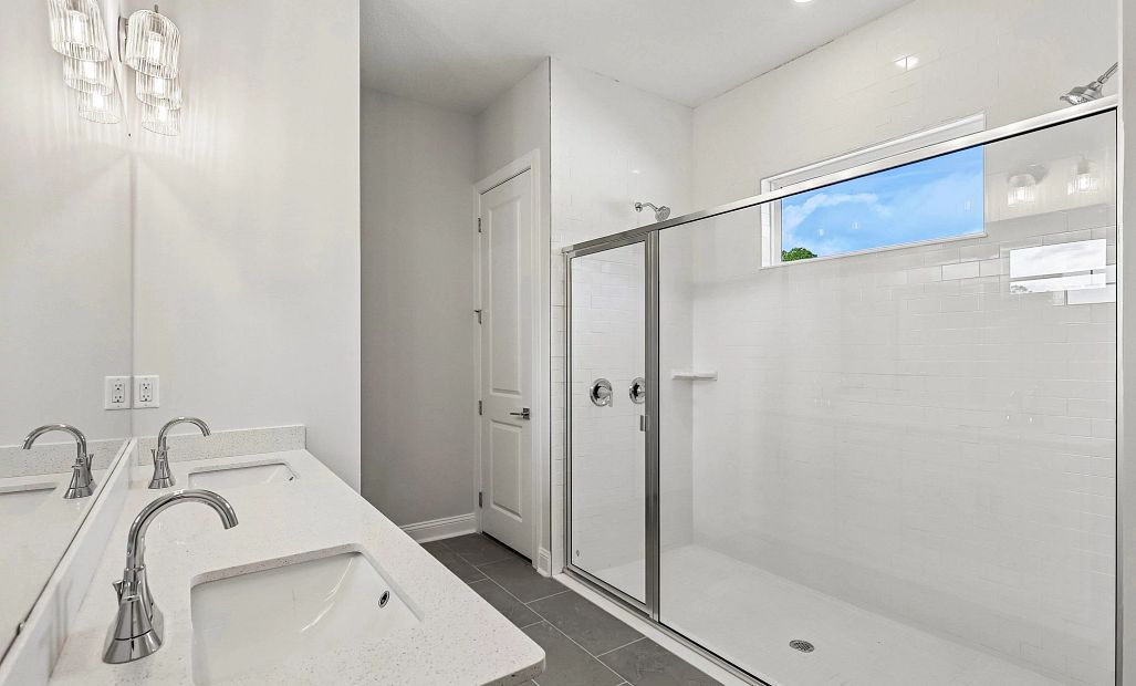 The primary bathroom features a large walk-in shower with double shower heads