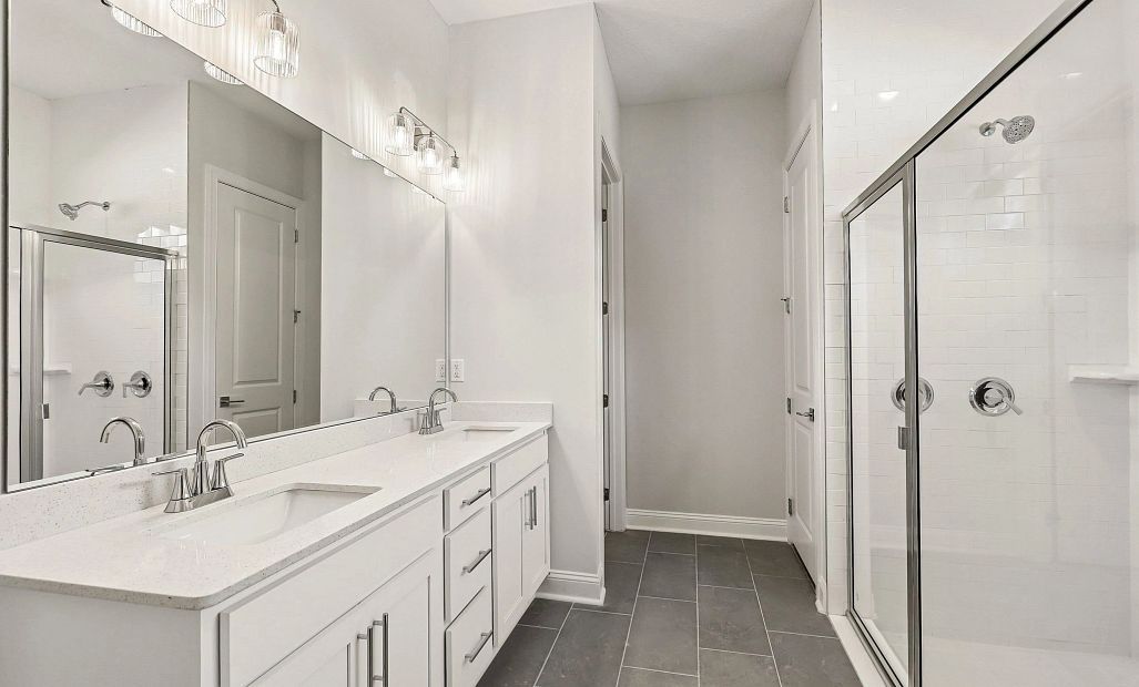 The primary bathroom also has a double sink vanity and linen closet
