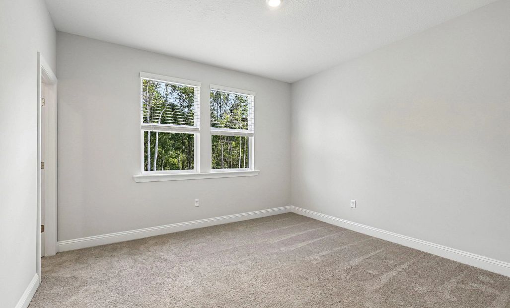In the back of the home is bedroom 4 with a connected bathroom