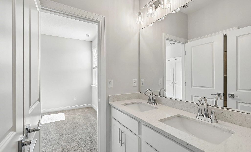 Jack and jill bathroom features a double sink vanity
