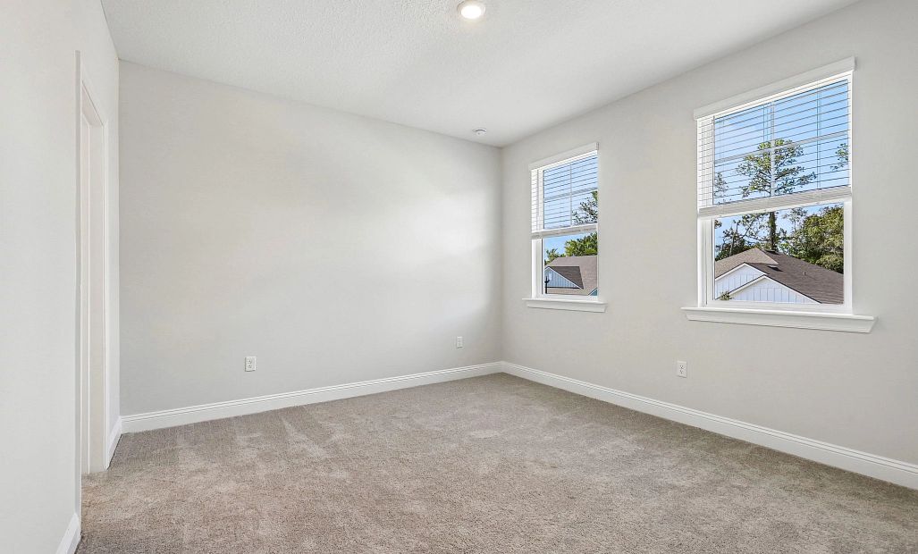 Bedroom 2 is on the other side of the jack and jill bathroom and is located at the front of the home