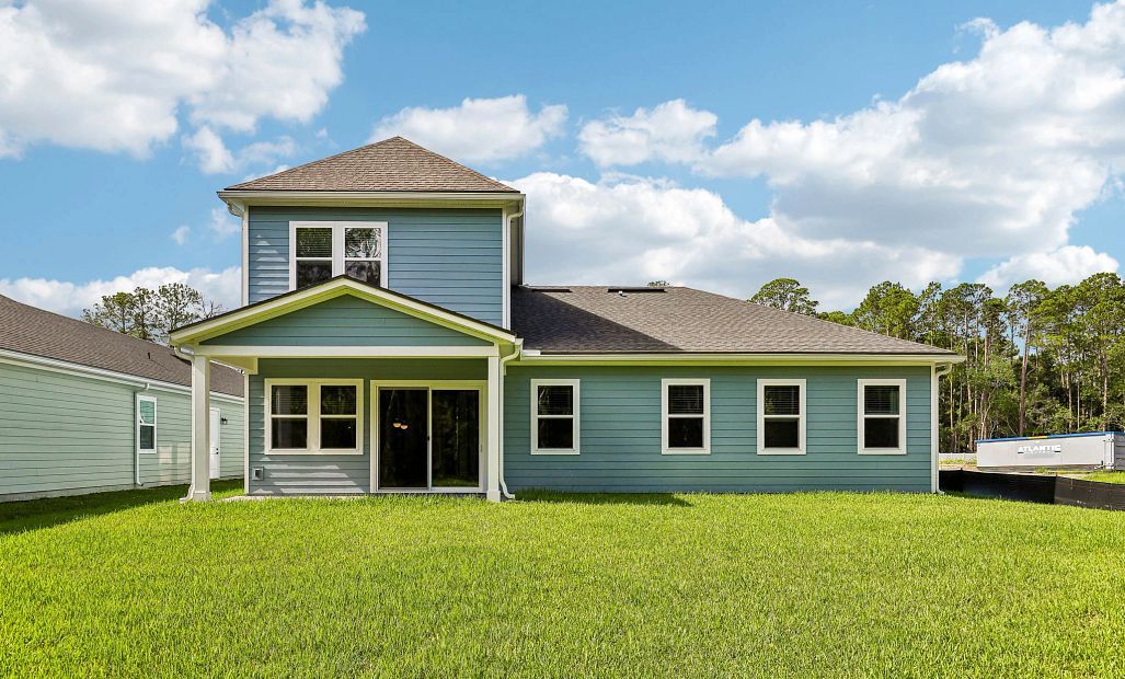 The back of the Coral home features a covered lanai and a generous sized yard
