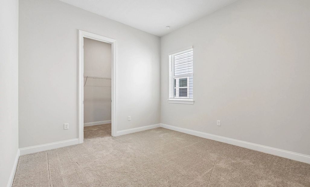 Spacious bedroom 2 with a walk-in closet