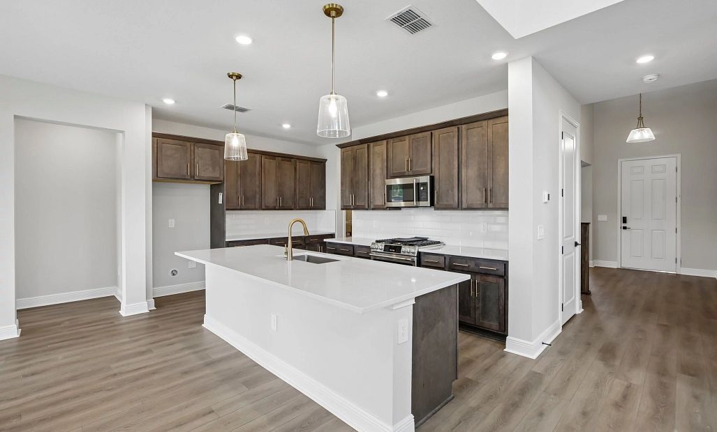 Spacious kitchen with a large island and plenty of cabinet space features AW Collection® Oxford