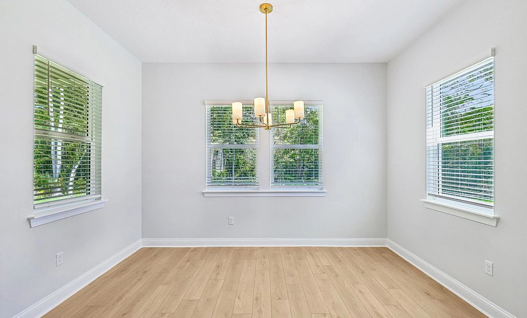 Off the kitchen is the dining space surrounded by windows making it a beautiful space to enjoy meals