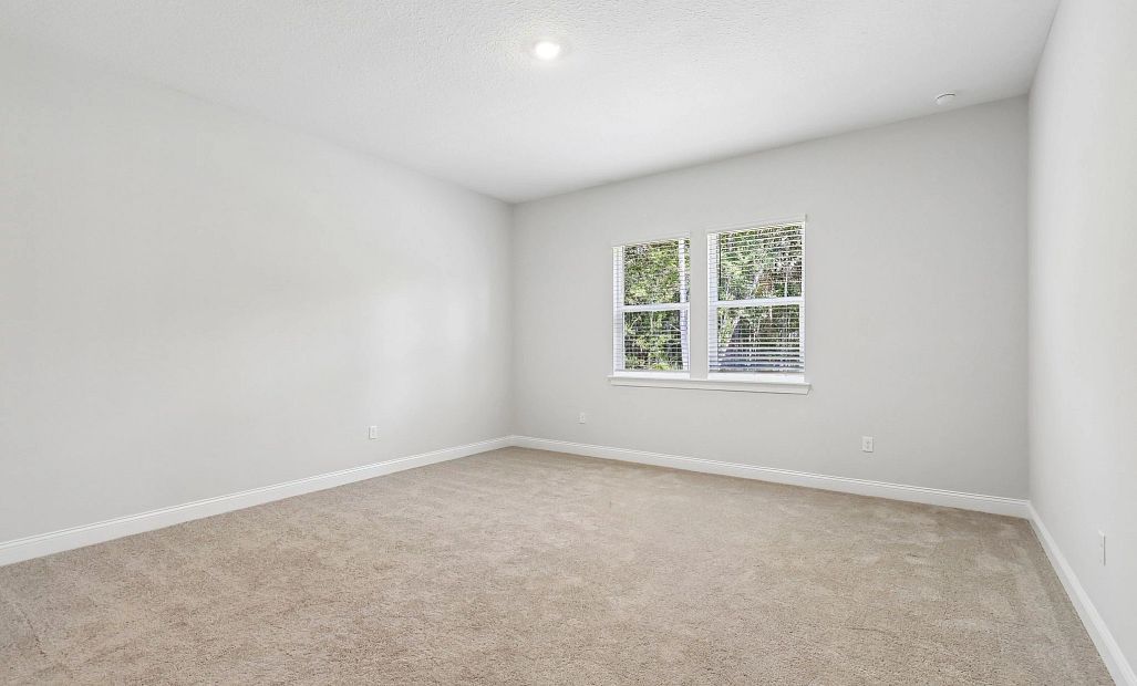 Primary bedroom with two large windows