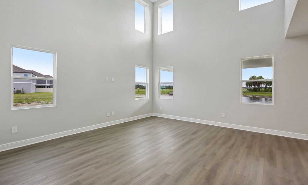Off the kitchen and dining nook is the two story family room featuring six large windows
