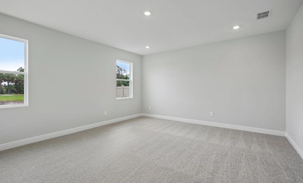 The primary bedroom is on the first floor located behind the kitchen