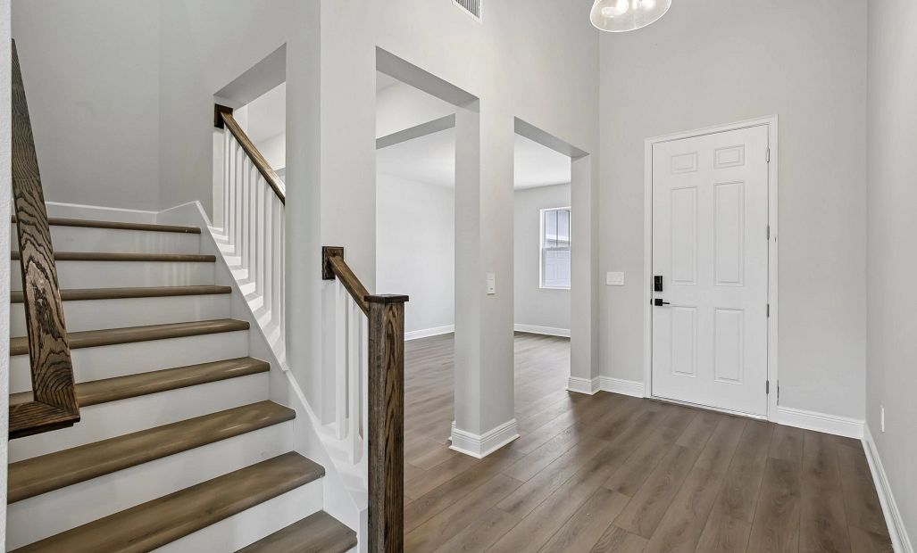 The open spindle staircase welcomes you up to the secondary bedrooms