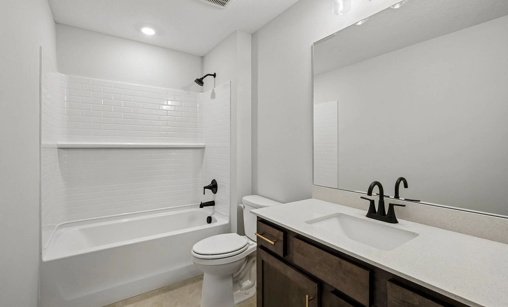 Bathroom 3 located off the hallway features aspects of AW Collection® Oxford