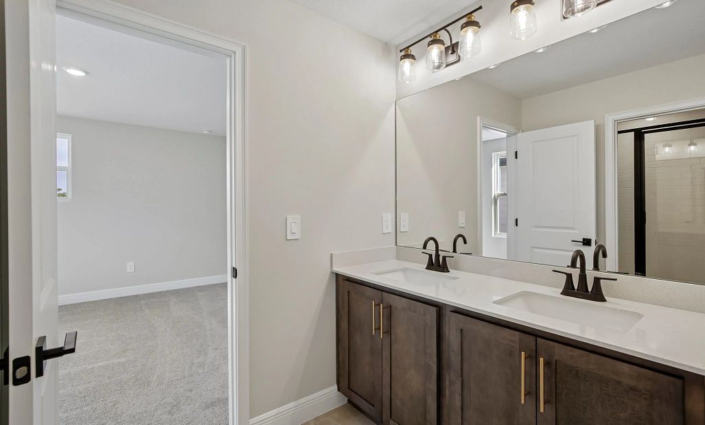 Bathroom 2 is a jack and jill bathroom that connects bedroom 3 and 4 featuring aspects of AW