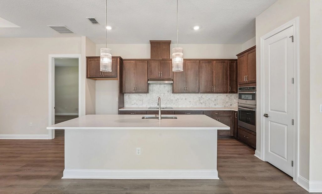 Large island centers the kitchen featuring AW Collection® Roosevelt
