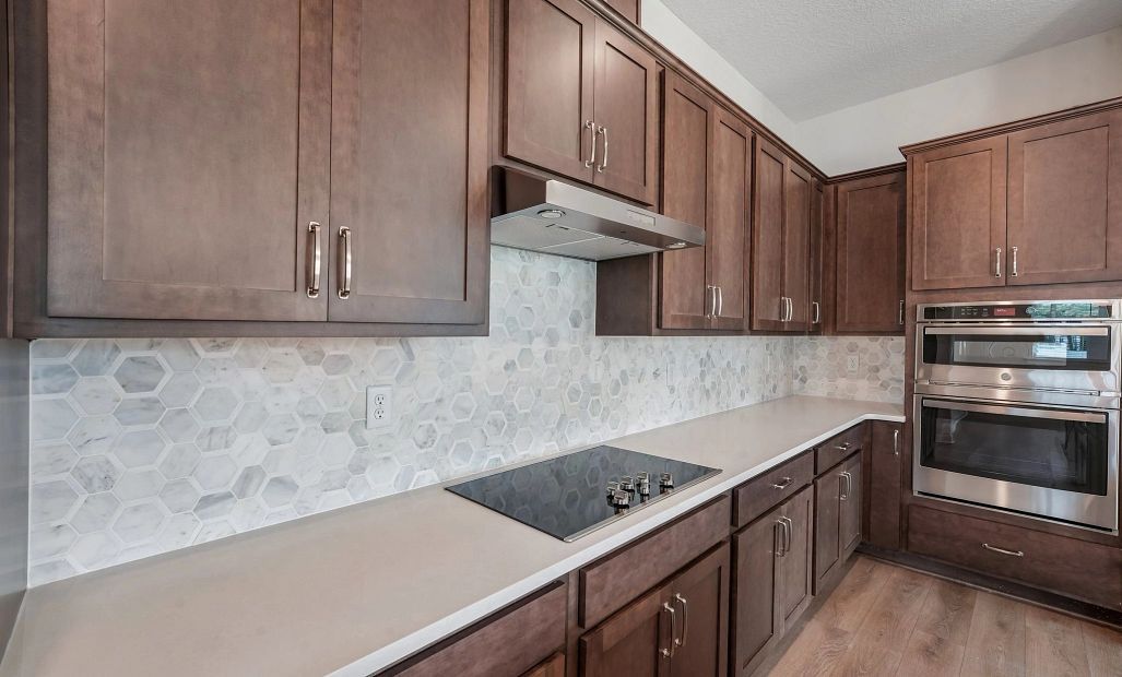 Stunning AW Collection® Roosevelt is the backdrop for the flat range, vent hood and double stack