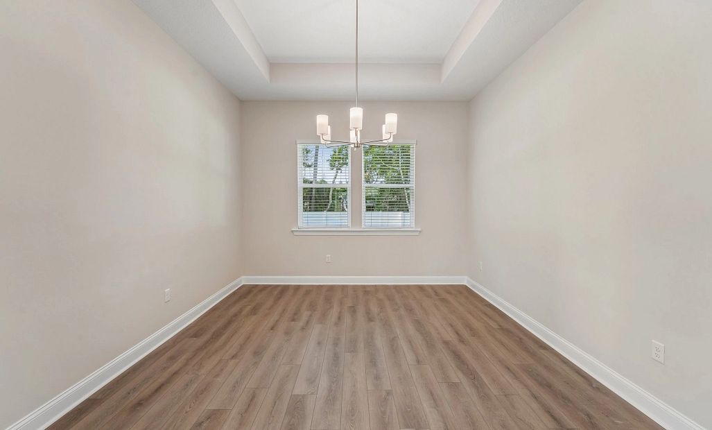 Dining room with a tray ceiling located just off the kitchen
