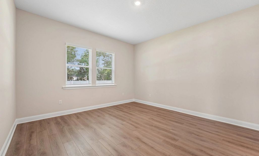 Primary bedroom featuring two large windows