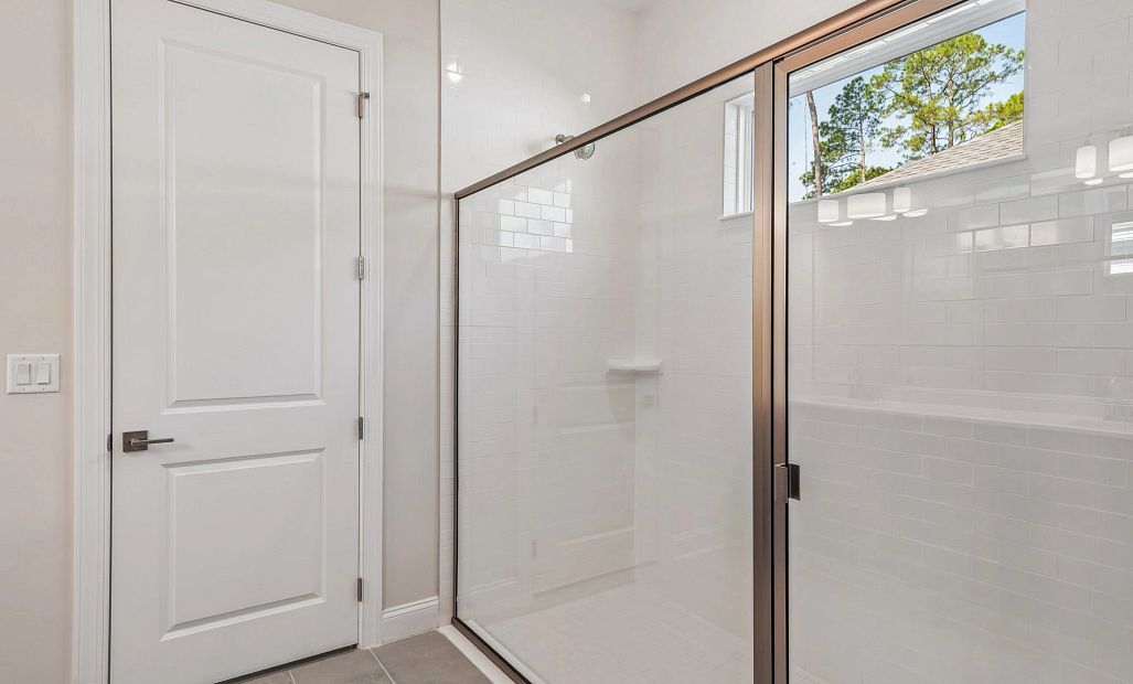 Primary bathroom features a large walk-in shower