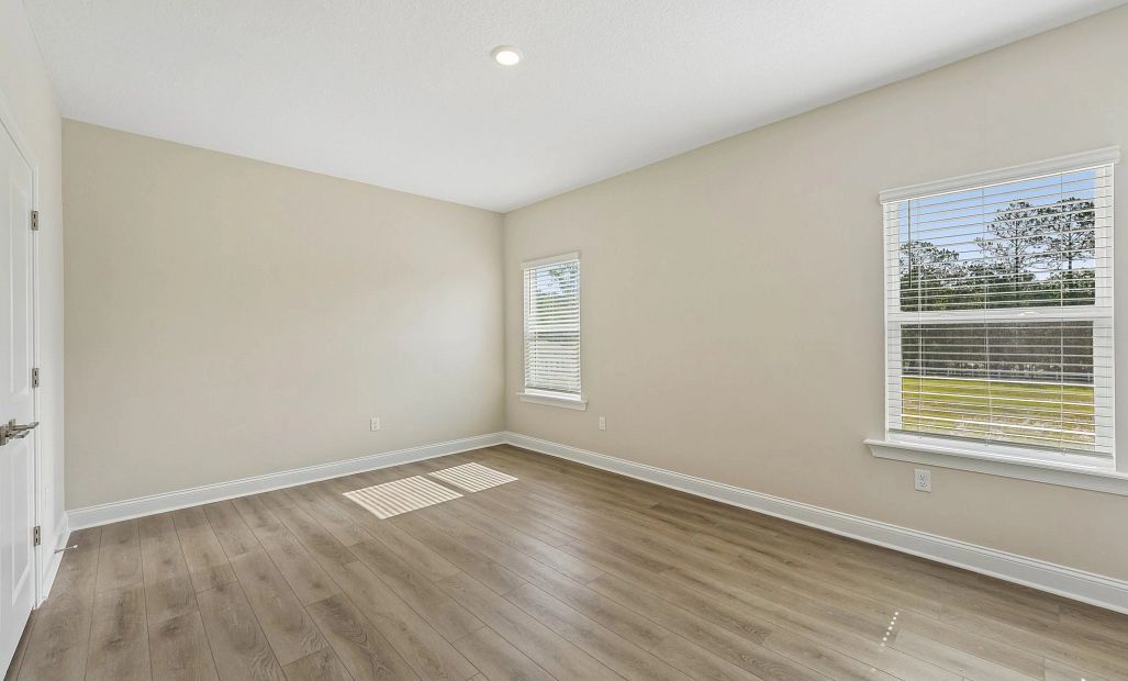 Bedroom 4 located upstairs features two large windows a perfect guest retreat