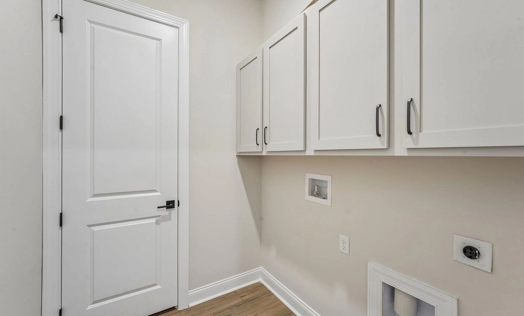 Laundry room featuring upper cabinets for extra storage