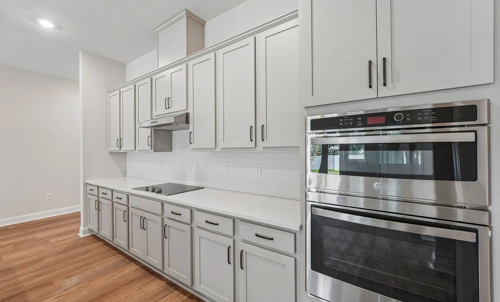 The AW Collection® Harmony kitchen features a double stack oven and microwave and a flat range with