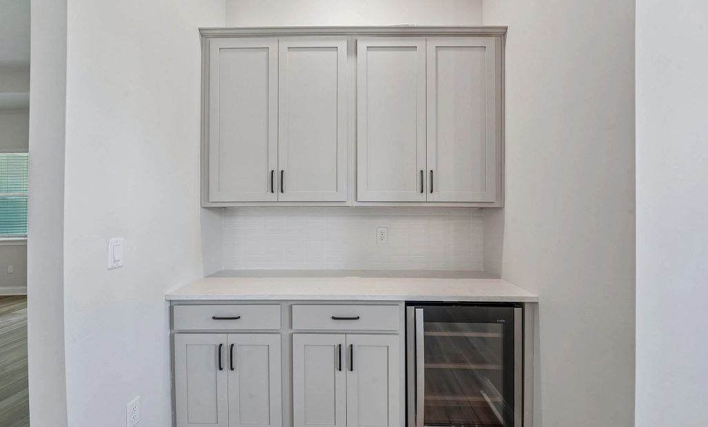 Off the dining room is a butler's pantry with a GE beverage fridge perfect for coffee or cocktails