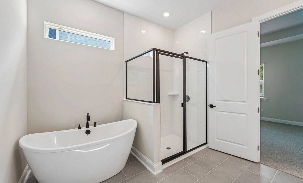The primary bathroom has a freestanding tub and a walk-in shower