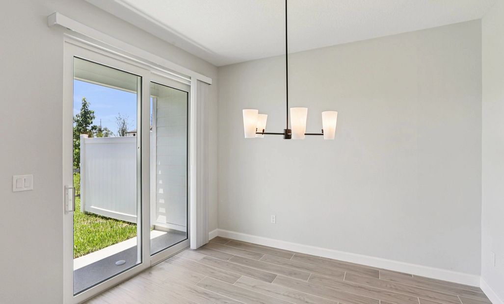 Dining room looks out on to the covered back lanai -  Representative images and renderings are for