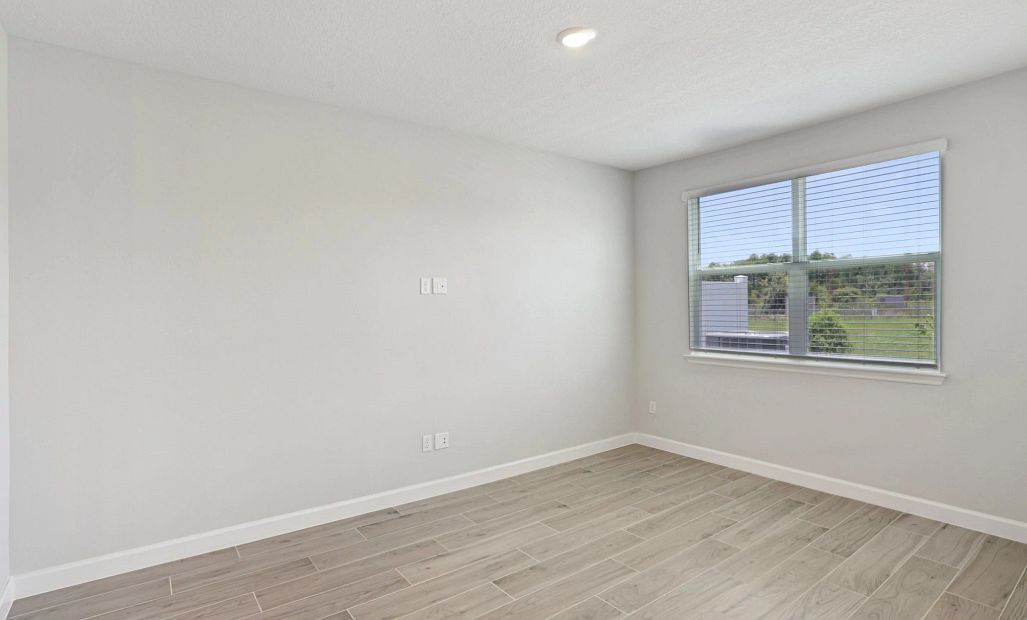 Spacious family room with a large double window -  Representative images and renderings are for