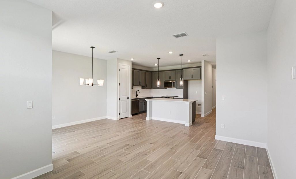 Open concept family room, dining room and kitchen -  Representative images and renderings are for