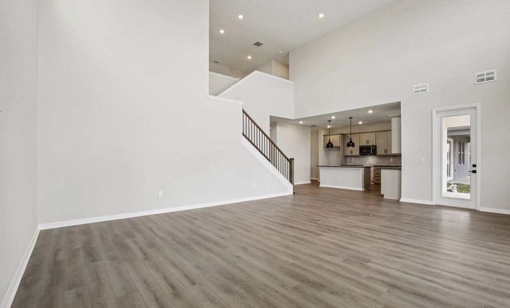 Two-story great room and stair spindles with railing - representative image this home will feature